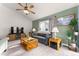 Comfortable living room with a ceiling fan, a plush sofa, and a decorative window at 2292 Brantner Pl, Brighton, CO 80601