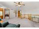 Spacious loft area with wooden banisters overlooking the lower level, perfect for relaxing at 2292 Brantner Pl, Brighton, CO 80601