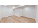 A clean basement space features modern flooring, neutral walls, and two doors at 3246 S Stuart St, Denver, CO 80236