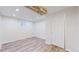 Basement bedroom featuring wood floors and a decorative wood beam at 3246 S Stuart St, Denver, CO 80236