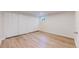 Basement bedroom with wood floors, closet, and a window at 3246 S Stuart St, Denver, CO 80236