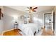 Bright bedroom features wood floors, ceiling fan, and a plush bed at 3246 S Stuart St, Denver, CO 80236