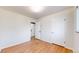 Unfurnished bedroom with wood floors, white walls, closet, and access to other rooms at 3246 S Stuart St, Denver, CO 80236