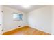 Unfurnished bedroom with wood flooring, one window, and white walls at 3246 S Stuart St, Denver, CO 80236