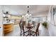 Open dining area with stylish chandelier, flowing into the living room and kitchen at 3246 S Stuart St, Denver, CO 80236