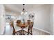 Cozy dining area with stylish chandelier, seamlessly connecting to the living room at 3246 S Stuart St, Denver, CO 80236