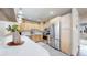 Well-lit kitchen featuring stainless steel appliances, quartz countertops and light wood cabinetry at 3246 S Stuart St, Denver, CO 80236