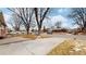 This charming neighborhood view showcases well-maintained homes and tree-lined streets at 3246 S Stuart St, Denver, CO 80236