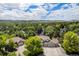 Stunning aerial view of a well-maintained home surrounded by lush greenery, with mountain views in the distance at 4541 Christensen Cir, Littleton, CO 80123