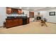 Basement bar with dark wood cabinets, granite countertop, sink, and wine storage at 4541 Christensen Cir, Littleton, CO 80123