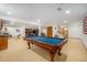 Spacious finished basement with pool table, wet bar, fireplace, and built-in bookshelves at 4541 Christensen Cir, Littleton, CO 80123