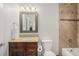 Stylish bathroom features a granite countertop, modern fixtures, and a shower-tub combo at 4541 Christensen Cir, Littleton, CO 80123