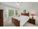 Inviting bedroom features a bright bay window, hardwood bed frame, and soft carpet at 4541 Christensen Cir, Littleton, CO 80123