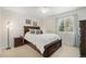 Comfortable bedroom with a queen-size bed, soft carpet, and natural light from the window at 4541 Christensen Cir, Littleton, CO 80123