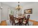 Elegant dining room features a large table, chandelier, and natural light from bay windows at 4541 Christensen Cir, Littleton, CO 80123