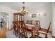 Elegant dining room features a large table, chandelier, and built-in display cabinet at 4541 Christensen Cir, Littleton, CO 80123