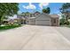 Spacious driveway leads to a charming two-story home with well-manicured lawn and attractive brick accents at 4541 Christensen Cir, Littleton, CO 80123