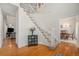 Bright foyer features hardwood floors, an elegant staircase, and a view into the dining room at 4541 Christensen Cir, Littleton, CO 80123