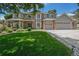 Charming two-story home boasts a well-manicured lawn, a three-car garage, and attractive brick accents at 4541 Christensen Cir, Littleton, CO 80123