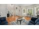 Bright living room features hardwood floors, staircase, and a large window with natural light at 4541 Christensen Cir, Littleton, CO 80123