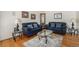 Cozy living room features hardwood floors, comfortable seating, and ample natural light at 4541 Christensen Cir, Littleton, CO 80123