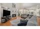 Bright living room with hardwood floors, fireplace, and open floor plan to kitchen at 4541 Christensen Cir, Littleton, CO 80123