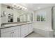 Well-lit main bathroom features a soaking tub, walk-in shower, and double sink vanity at 4541 Christensen Cir, Littleton, CO 80123