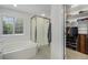 Bright bathroom featuring a tub, glass-enclosed shower, and walk-in closet at 4541 Christensen Cir, Littleton, CO 80123
