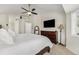 Bright bedroom with a ceiling fan, dresser, and large bed, creating a welcoming space at 4541 Christensen Cir, Littleton, CO 80123