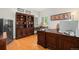 Executive home office with wood paneled desk, built in shelves, and natural light at 4541 Christensen Cir, Littleton, CO 80123