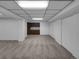 Basement featuring neutral carpeting, a drop ceiling with lighting, and a wet bar area at 9645 W 73Rd Pl, Arvada, CO 80005