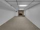 Carpeted basement with stone fireplace and hearth at 9645 W 73Rd Pl, Arvada, CO 80005