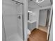 Bathroom featuring wood-look flooring, a walk-in shower, and a vanity with a sink at 9645 W 73Rd Pl, Arvada, CO 80005