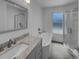 Modern bathroom features a standalone tub, walk-in shower, and gray vanity at 9645 W 73Rd Pl, Arvada, CO 80005