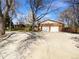 Long driveway leading to a two-car garage, providing ample parking space at 9645 W 73Rd Pl, Arvada, CO 80005