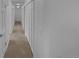 Bright hallway with neutral carpet and white doors with lights overhead at 9645 W 73Rd Pl, Arvada, CO 80005