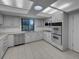Bright kitchen with white cabinets, stainless steel appliances, and tile flooring at 9645 W 73Rd Pl, Arvada, CO 80005