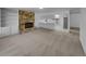 Bright living room features a stone fireplace, built-in shelves, and an open layout to the kitchen at 9645 W 73Rd Pl, Arvada, CO 80005
