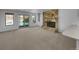 Spacious living room with a stone fireplace and sliding door access to the backyard at 9645 W 73Rd Pl, Arvada, CO 80005