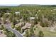 Stunning aerial view of a home nestled in a wooded area with mature trees and mountain views at 5091 Hidden Pond Pl, Castle Rock, CO 80108