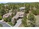 An aerial view of a well-situated house with mature trees, and lush landscaping for ultimate privacy at 5091 Hidden Pond Pl, Castle Rock, CO 80108