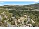 Stunning aerial view of a neighborhood nestled among lush greenery, providing a serene and private setting at 5091 Hidden Pond Pl, Castle Rock, CO 80108