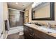 Full bathroom featuring dual sinks, a vanity with granite countertops, and a shower-tub combination at 5091 Hidden Pond Pl, Castle Rock, CO 80108