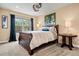 Comfortable bedroom with a ceiling fan, carpet flooring, and a large window with views at 5091 Hidden Pond Pl, Castle Rock, CO 80108