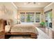 Spacious bedroom featuring a modern bed frame, natural light, and access to an outdoor area at 5091 Hidden Pond Pl, Castle Rock, CO 80108