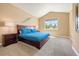 Bright bedroom with a high ceiling, large window, and comfortable furnishings at 5091 Hidden Pond Pl, Castle Rock, CO 80108