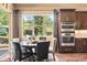 Charming breakfast nook with built in cabinets, stainless steel oven, and scenic outdoor view at 5091 Hidden Pond Pl, Castle Rock, CO 80108