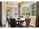 Bright breakfast nook with views of lush landscaping and a water feature at 5091 Hidden Pond Pl, Castle Rock, CO 80108