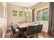Elegant dining room features a modern chandelier and windows that bring in natural light at 5091 Hidden Pond Pl, Castle Rock, CO 80108