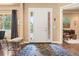 Inviting foyer with hardwood floors, white door with sidelights, and decorative rug enhancing its appeal at 5091 Hidden Pond Pl, Castle Rock, CO 80108